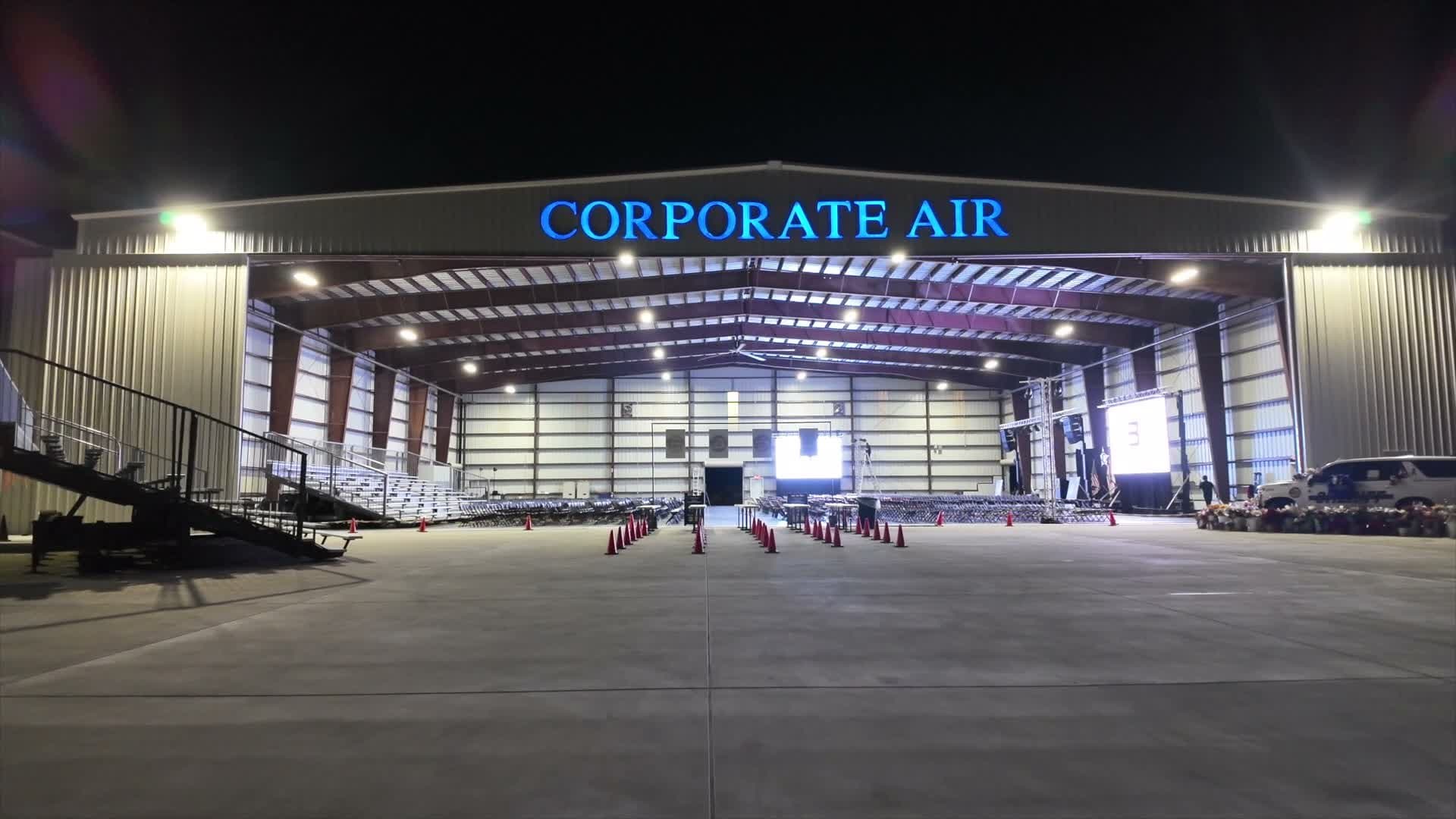 Fully staged aircraft hangar lit at night ahead of the Indian River County memorial service
