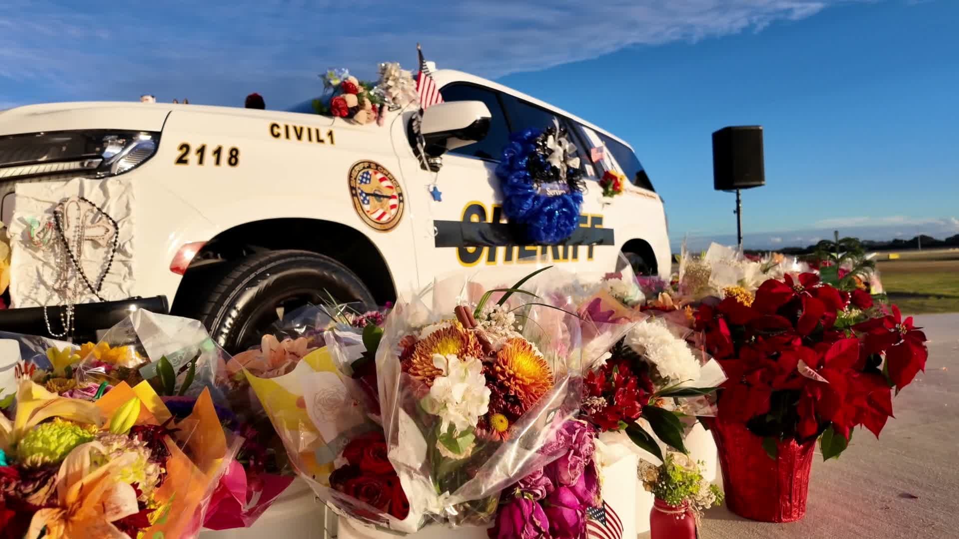 Flowers and tributes placed on an Indian River County Sheriff's Office vehicle